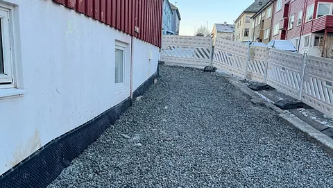 Ledninger og rør er synlige i grop gravd i jord